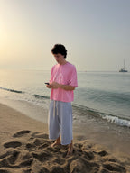 Yellow Star Gray Pant worn by a model on the beach at sunset, front view
